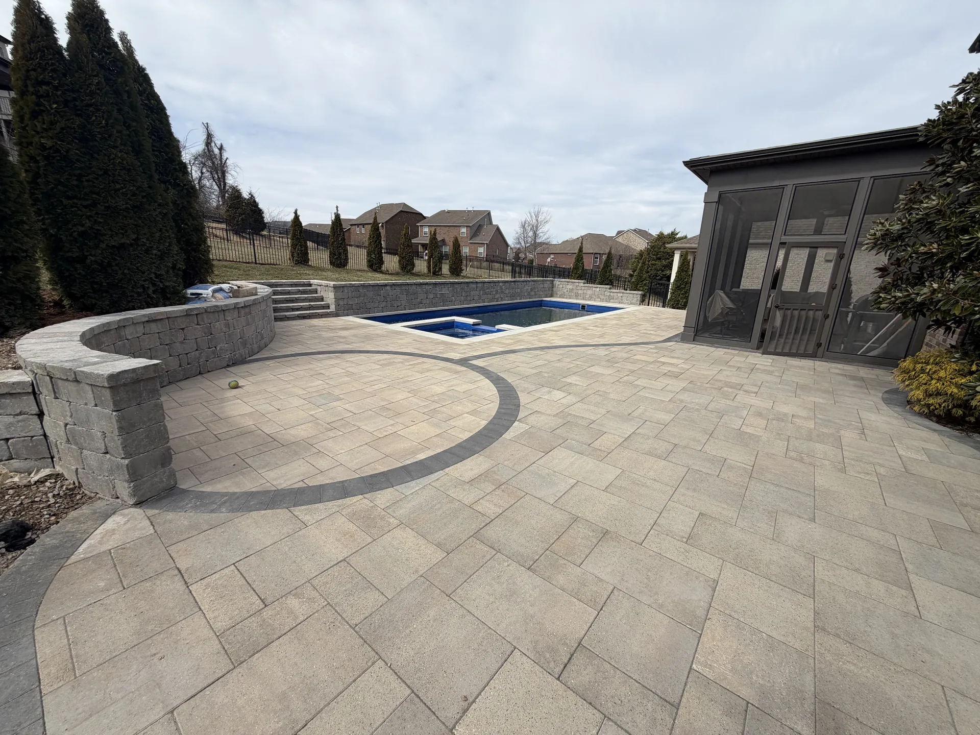 Travertine patio and pavilion hardscape beside a custom pool